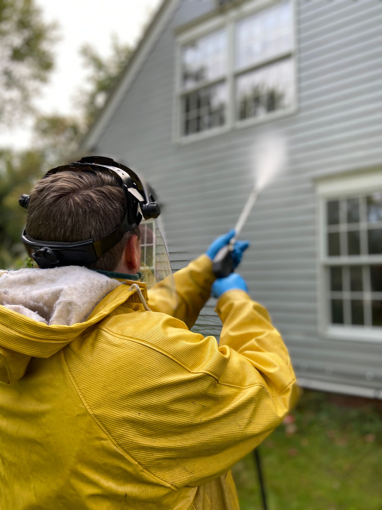House siding being pressure washed in North Hills